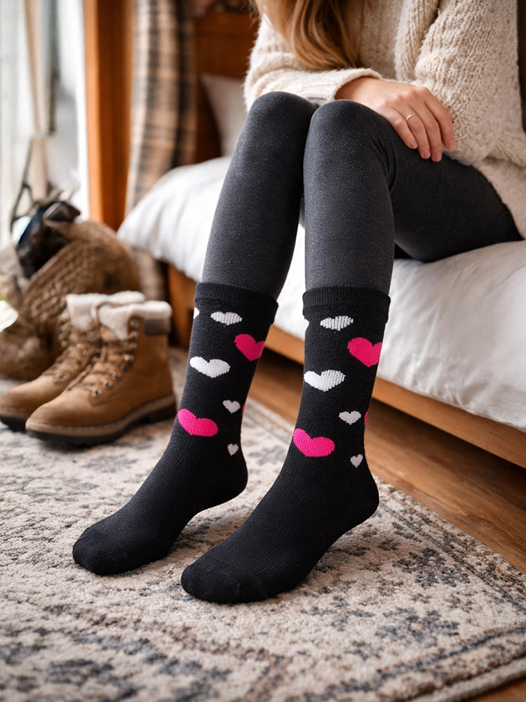 Women wearing black knee-high socks with heart patterns sitting on a bed.

Active Star Ladies Thermal Fashion Socks Pack of 3 